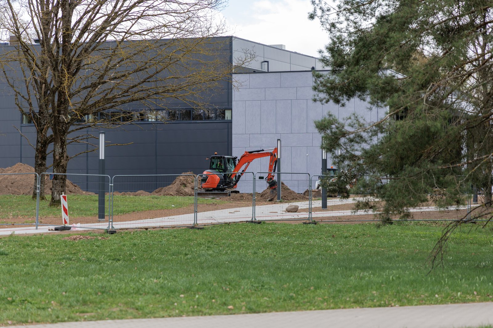 Segregated works beside an operational commercial building