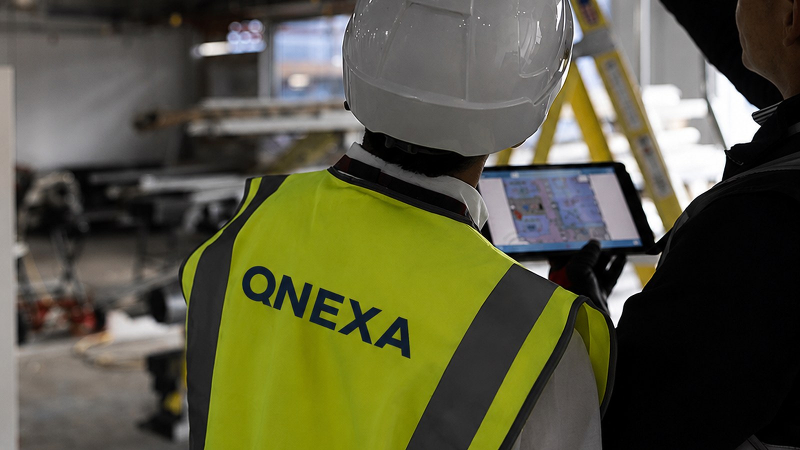 Site works in progress, operative reviewing drawings on site